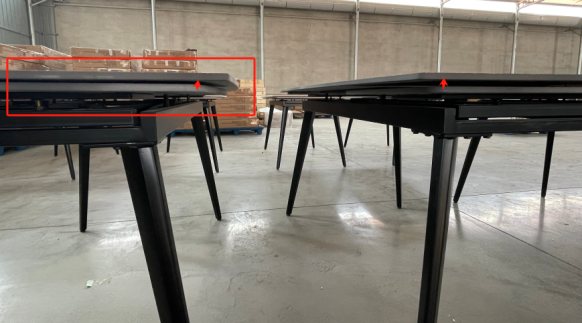Dining table being checked during a furniture inspection